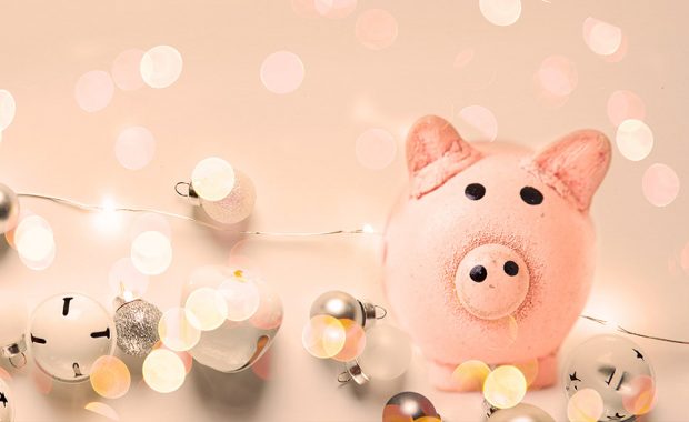 Pig money box surrounded with festive lights